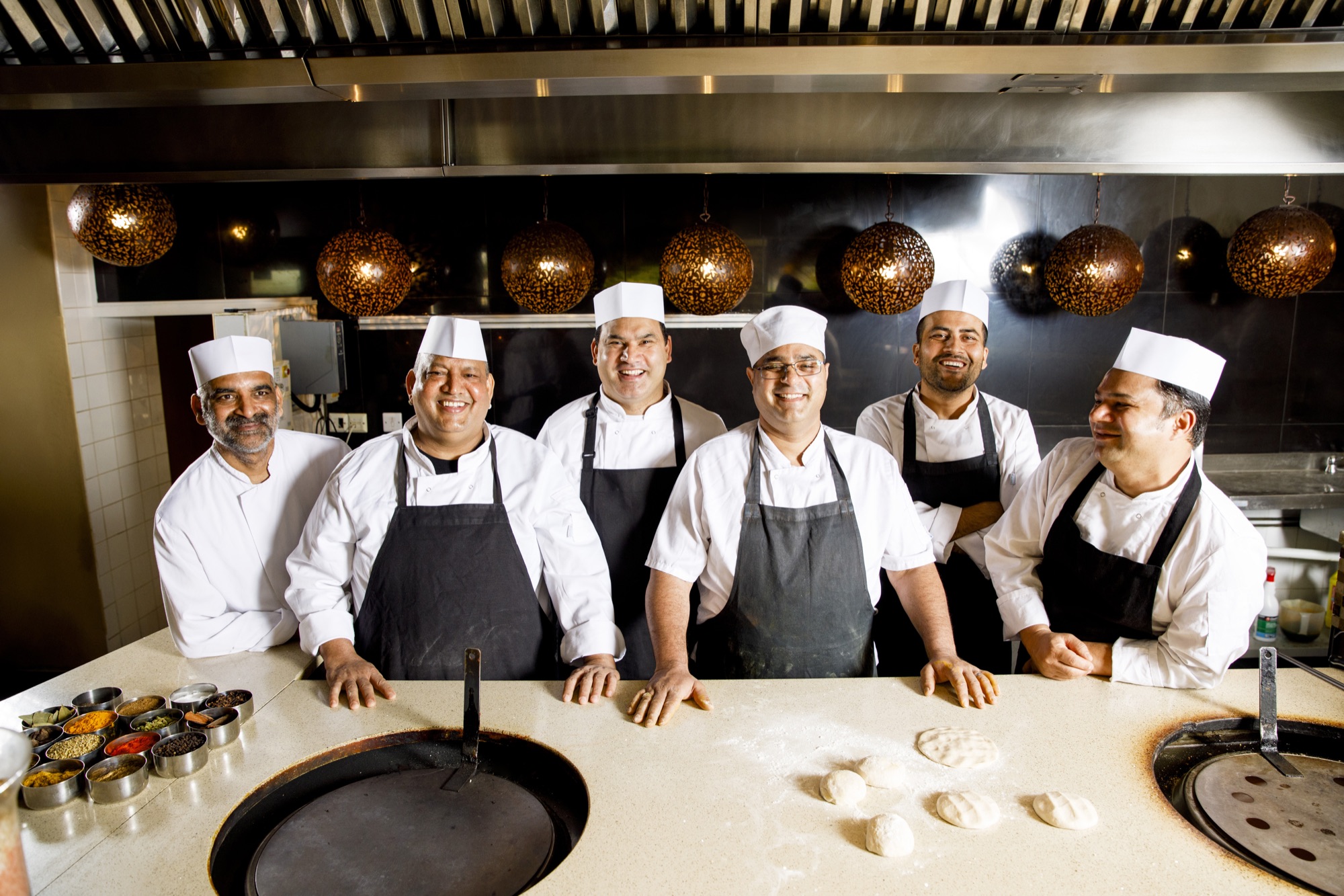A Rasoi waiter setting a banquet table