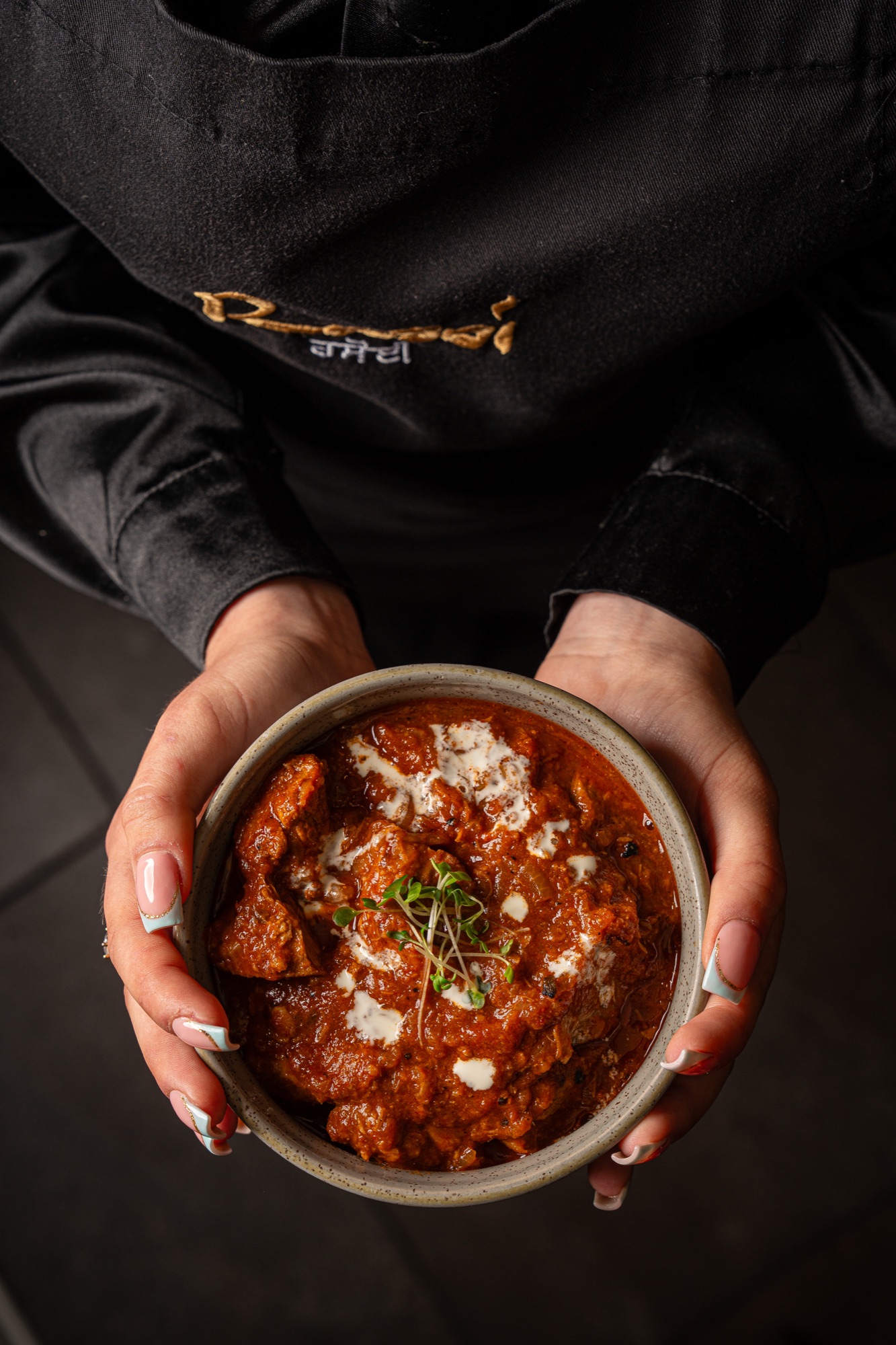 At the Rasoi pass — chef finishing a dish
